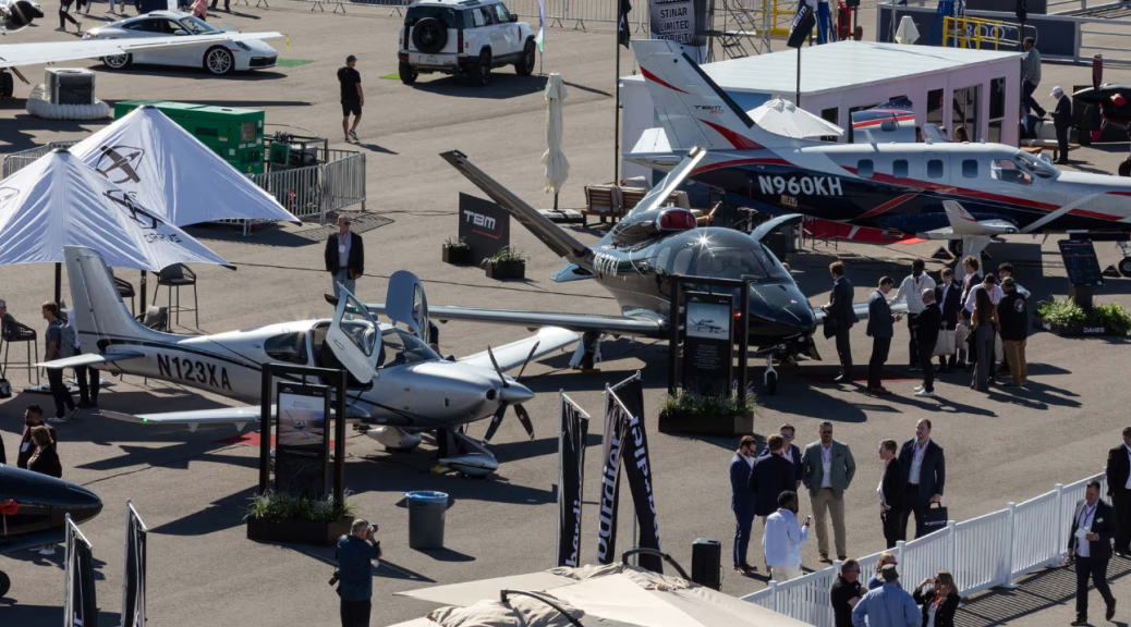 Photo from the NBAA-BACE website that features a previous conference where a lot of beautiful planes are on display.