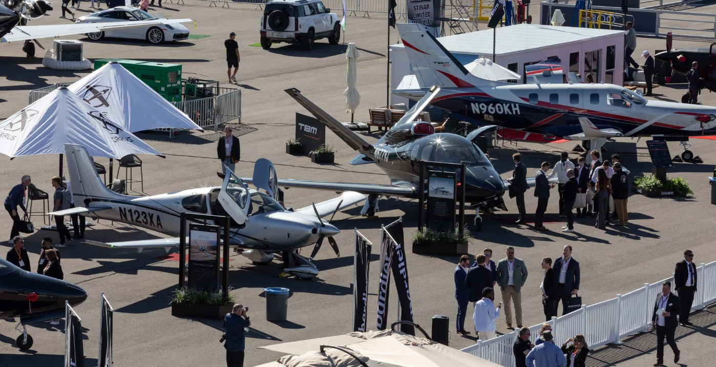 Photo from the NBAA-BACE website that features a previous conference where a lot of beautiful planes are on display.